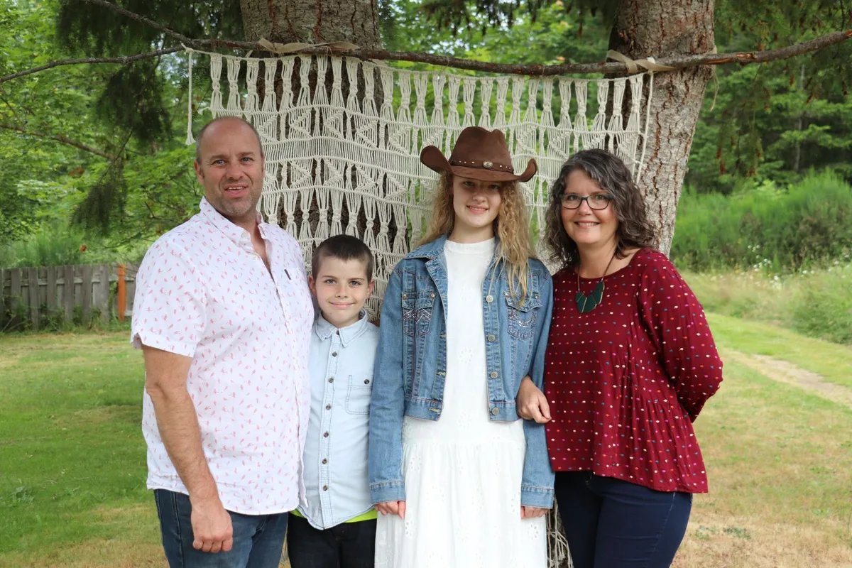 The Baldwin family, the family behind Clear and Clean Services, standing outdoors in a green yard